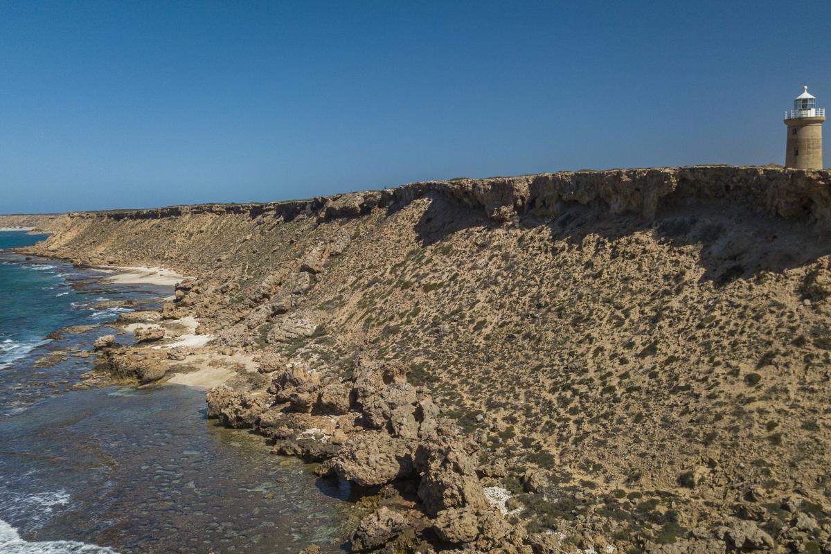 lighthouse at the top of the cliffs at cape inscription