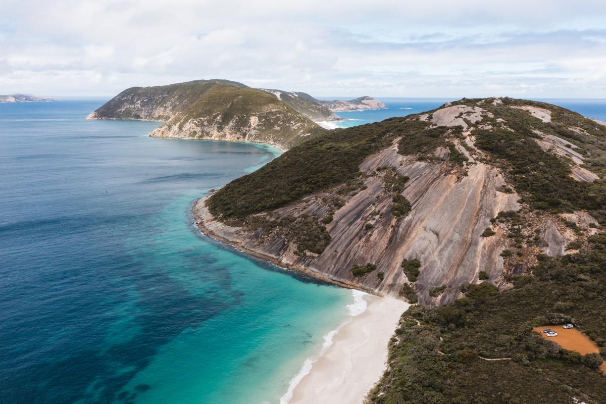 Aerial view of a peninsula with a trail. 