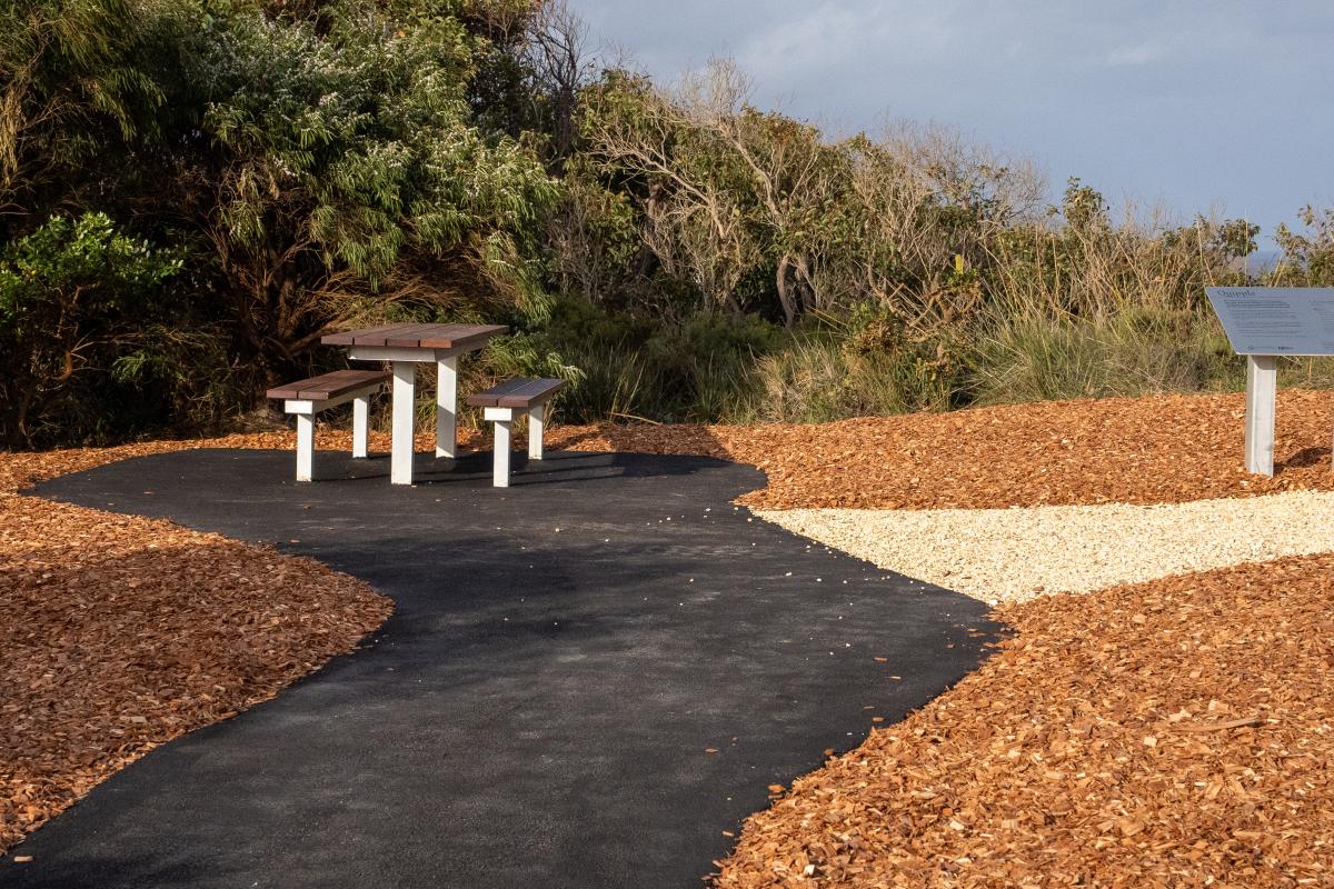 Misery Beach Picnic bench and table at the end of a path.