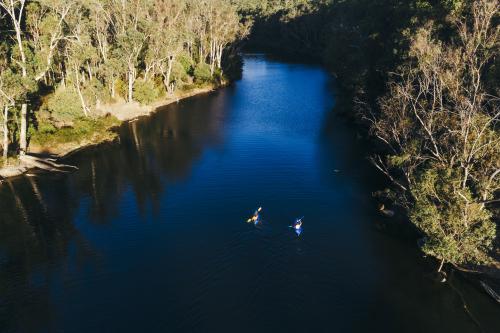 Aerial view of river with tow people paddling in kayaks