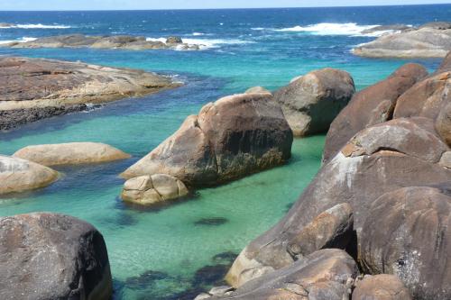 granite rocks in the calm clear blue waters