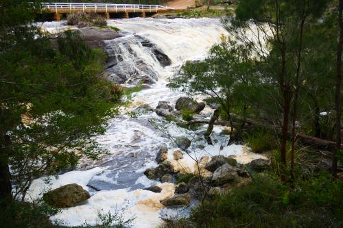 water falls over granite rocks at fernhook falls