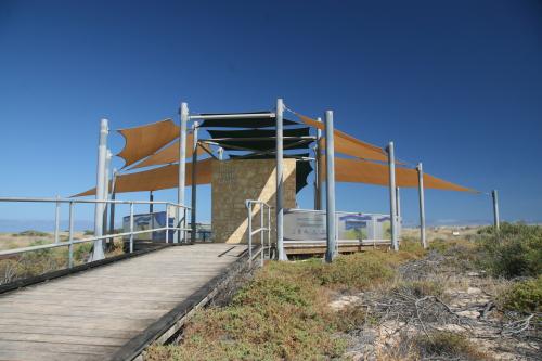 Structure with shade sails for interpretive signage about turtles