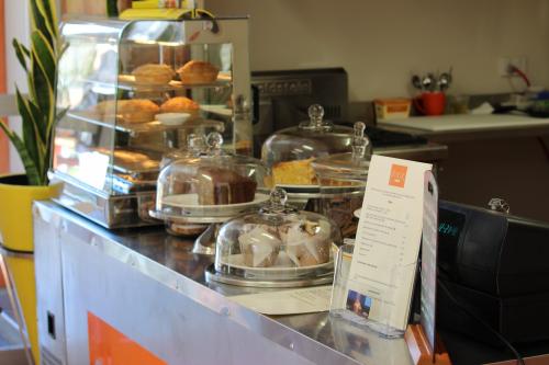cakes and muffins in a display counter in a kiosk