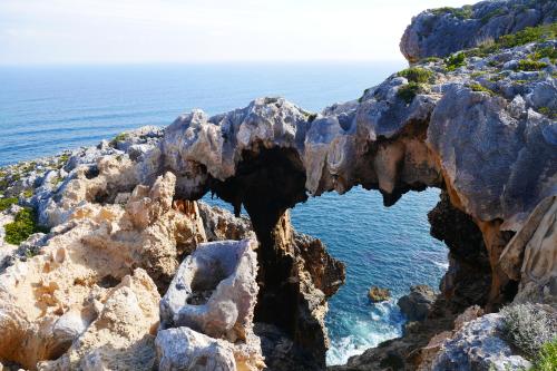 eroded coastal limestone that forms a window with views to the ocean
