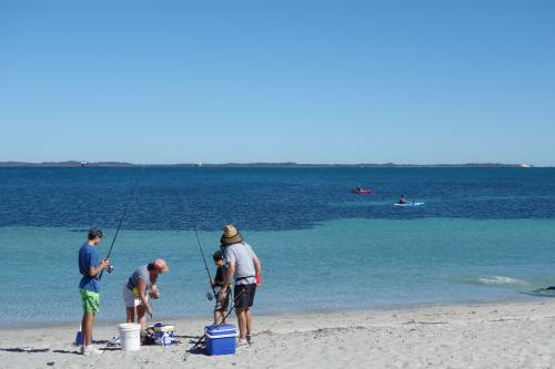 People fishing from the beach at Woodman Point.