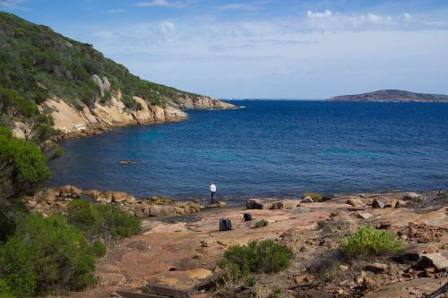 Rocky island with heavy vegetation overlooking other islands in the archipelago.