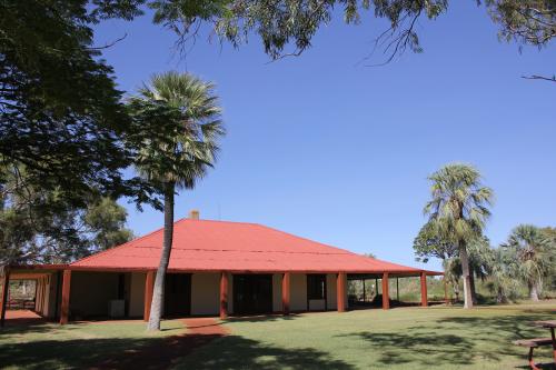 historic millstream homestead surrounded by green lawns and shady trees