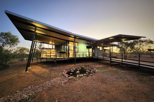 Looking at the visitor centre building at dusk with the lights on 