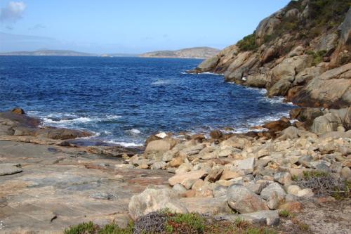 A bay surrounded by granite rocks. 