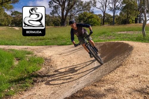 Person riding mountain bike on trails. 