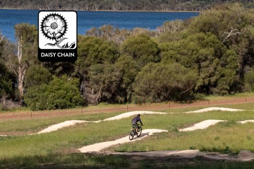 Person riding mountain bike on trails.