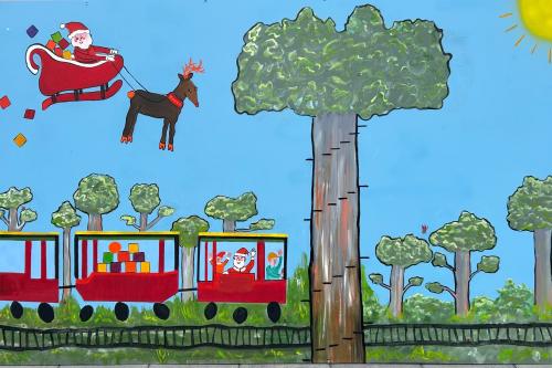 Colourful artwork of a train and Santa and a reindeer flying above. 