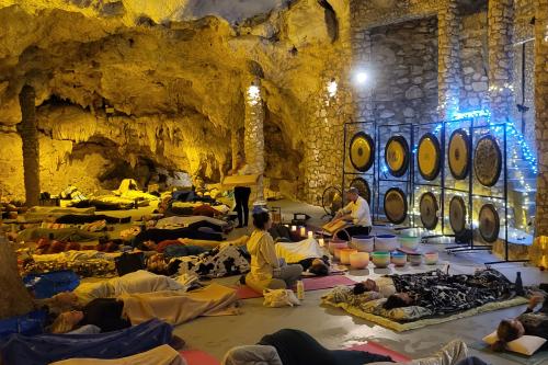 People doing yoga inside a cave. 