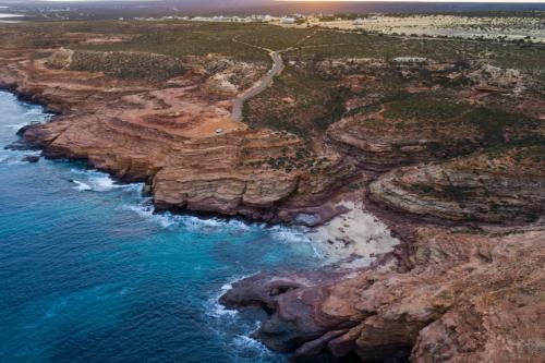 View of tall limestone cliffs on the ocean. 