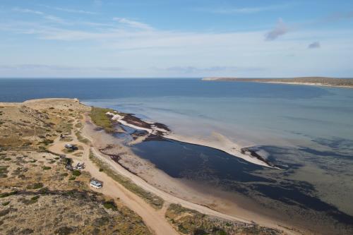 Aerial view of sandy campsites near the beach. 