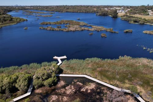 An aerial view of a boardwalk over a lake. 