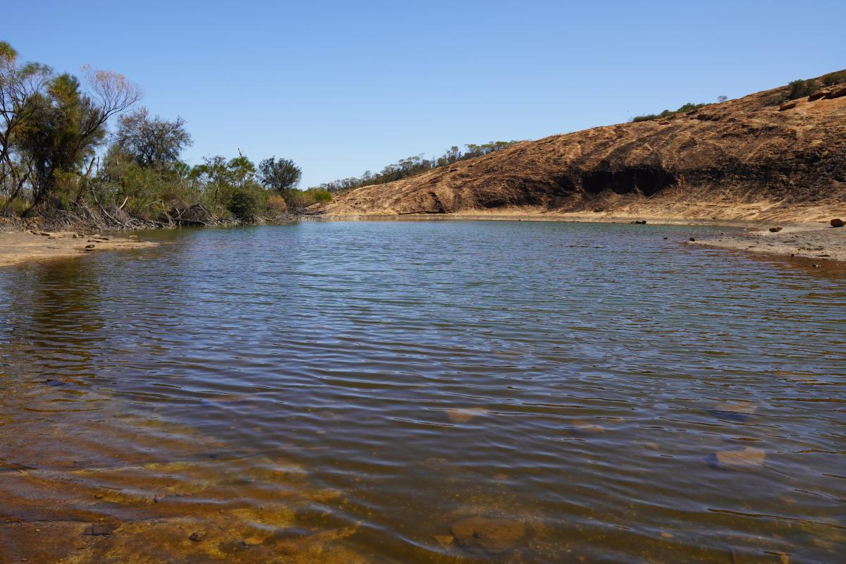 water in a dam surrounded by rocks