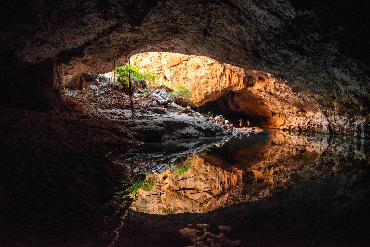 view of dark tunnel with water running throough