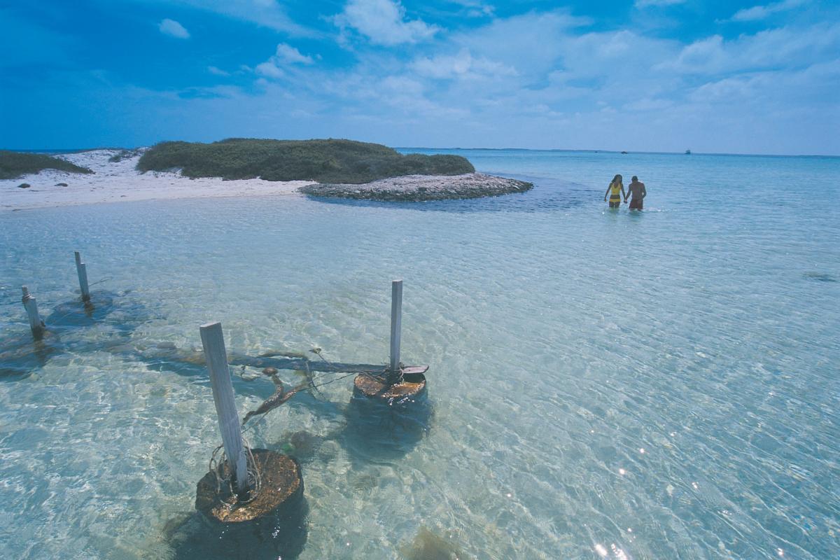 Houtman Abrolhos Islands National Park old wooden jetty couple walking in water