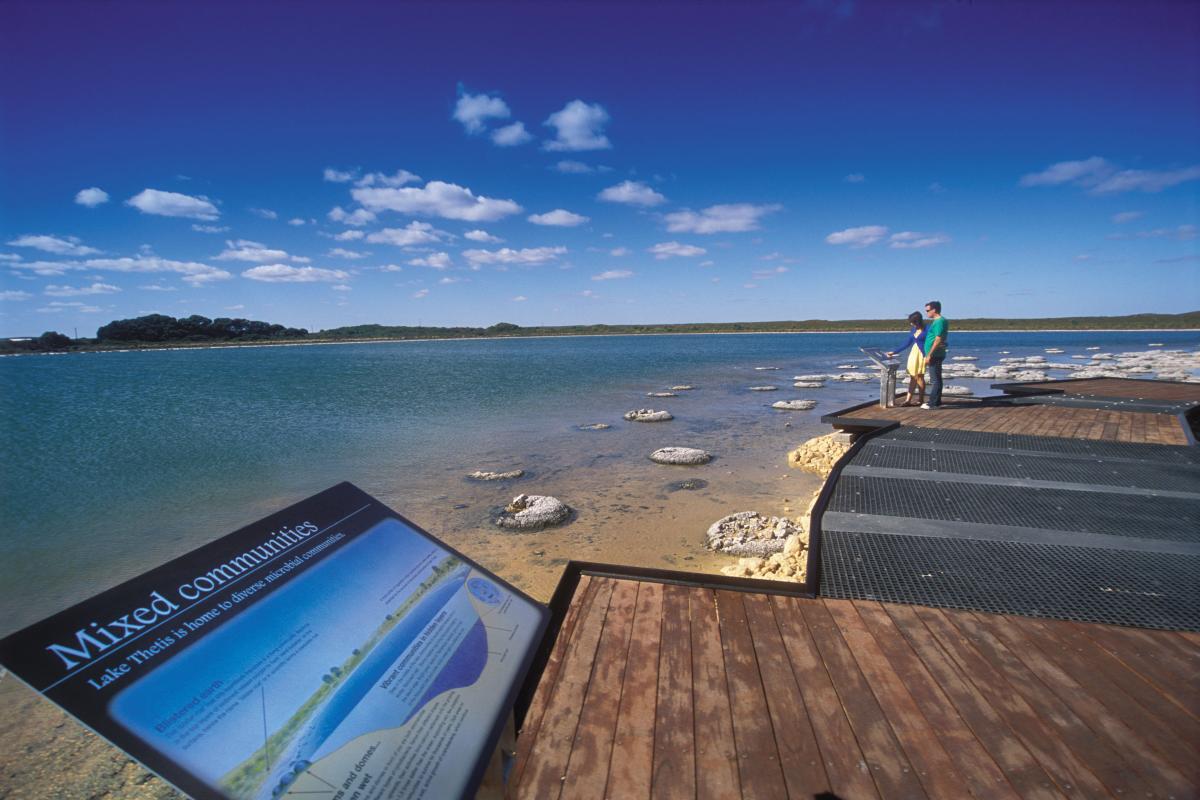 Lake Thetis Nambung National Park two people on elevated viewing platform of important ancient rock like formations with information sign in the foreground