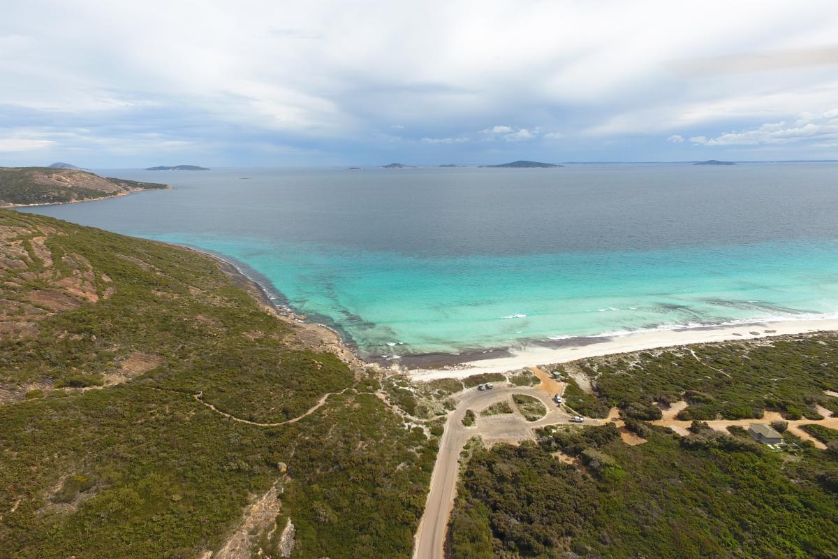 aerial view of dirt roads and campsites near beach