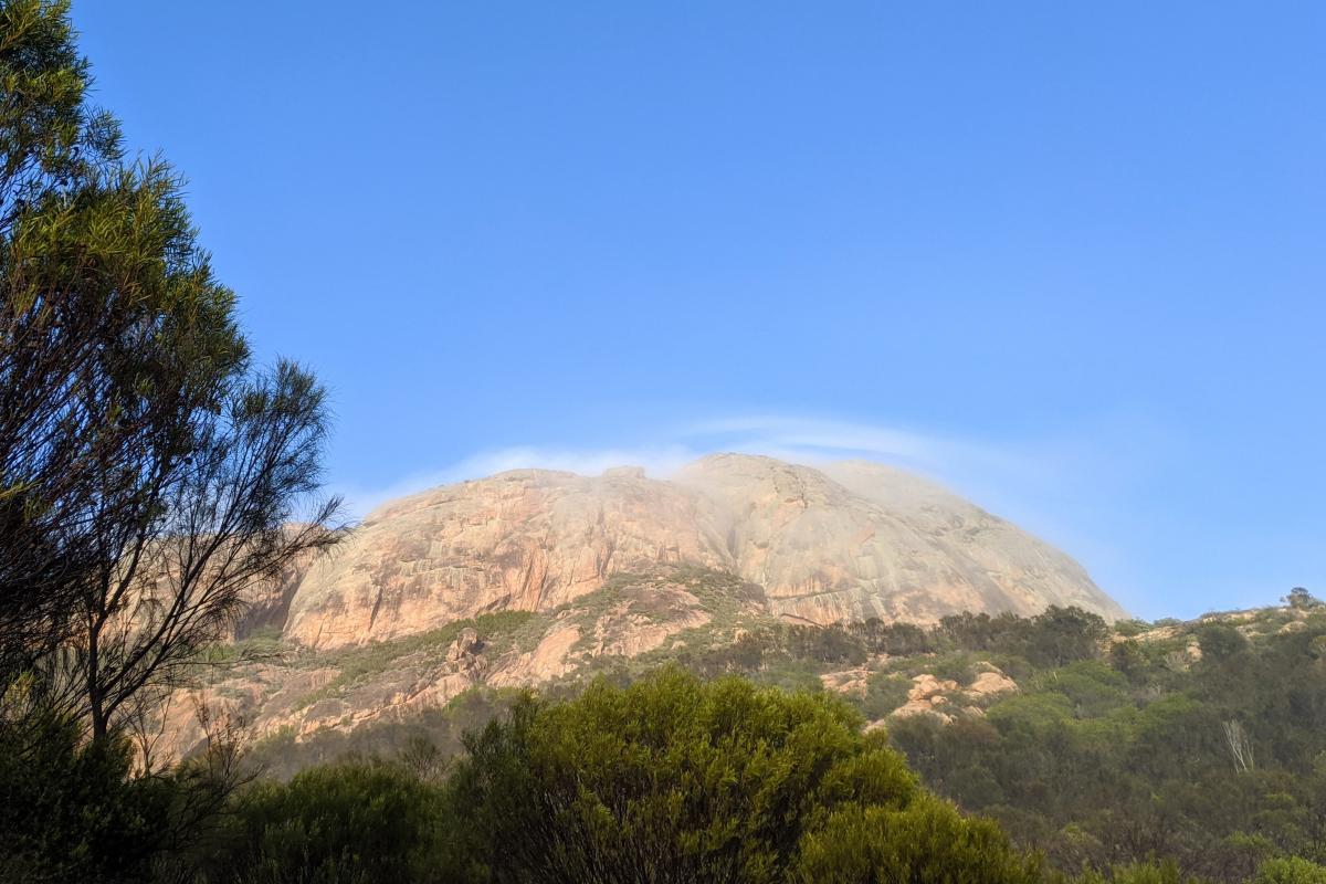 Misty cloud over a peak with blue sky