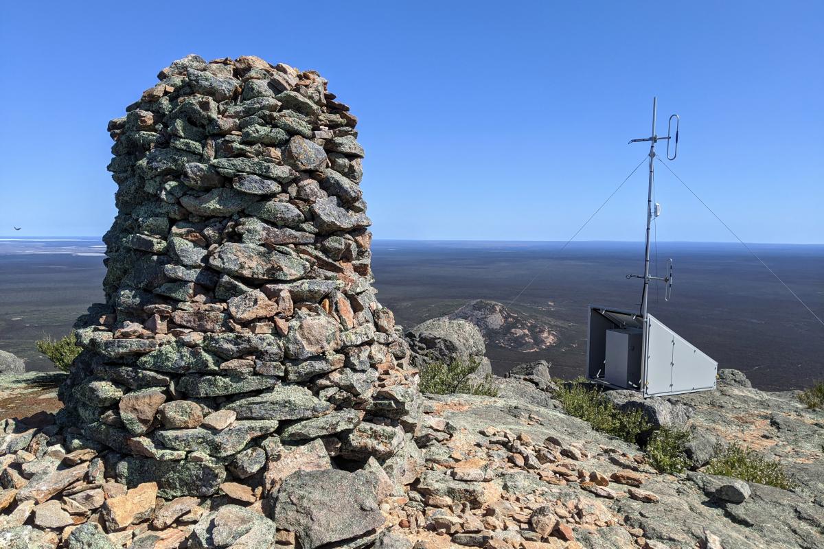 A man made rock cairn on top of a peak