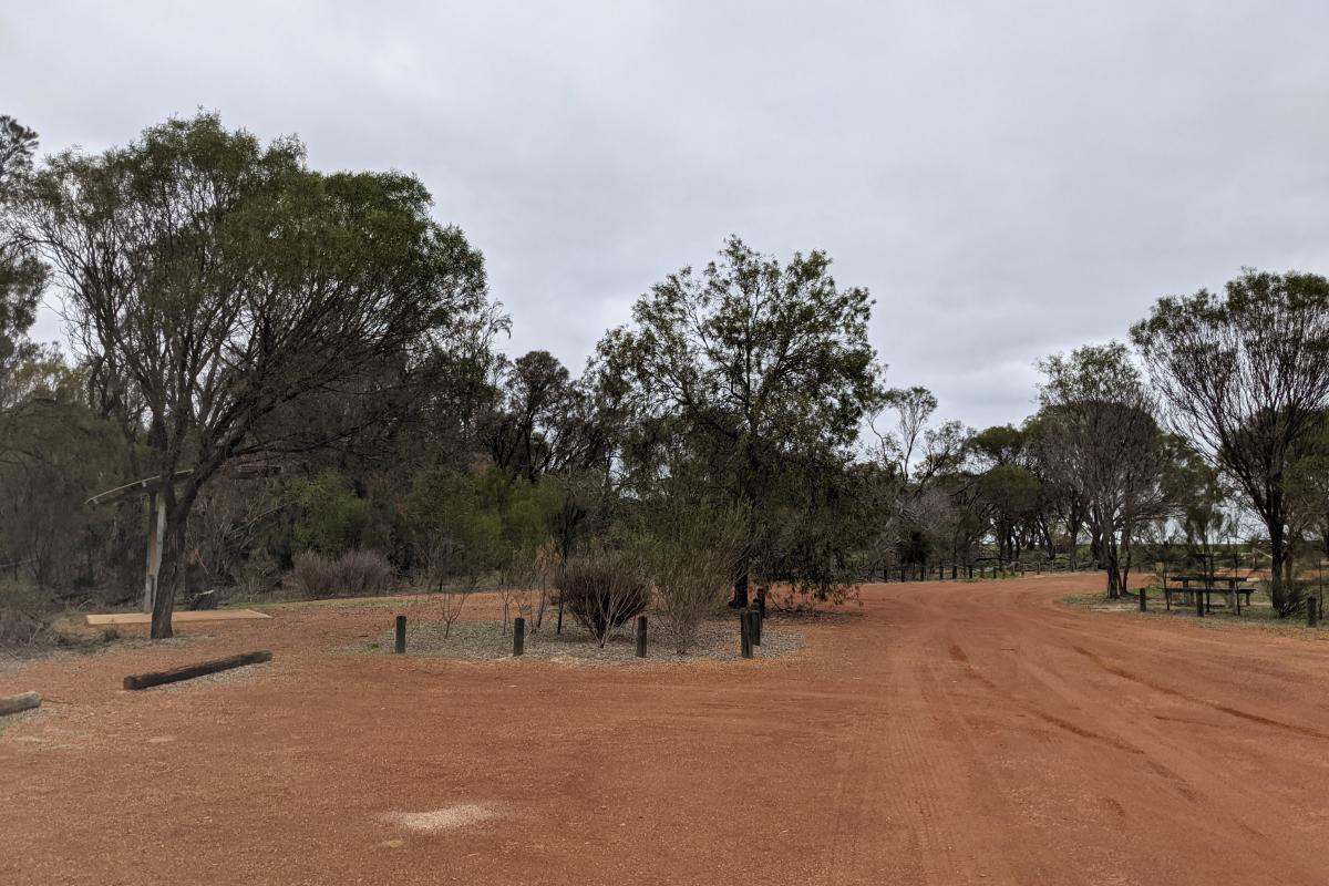 Large gravel carpark and picnic benches at the old Pioneer Well next to Kokerbin Rock Gravel carpark with information shelter and picnic benches