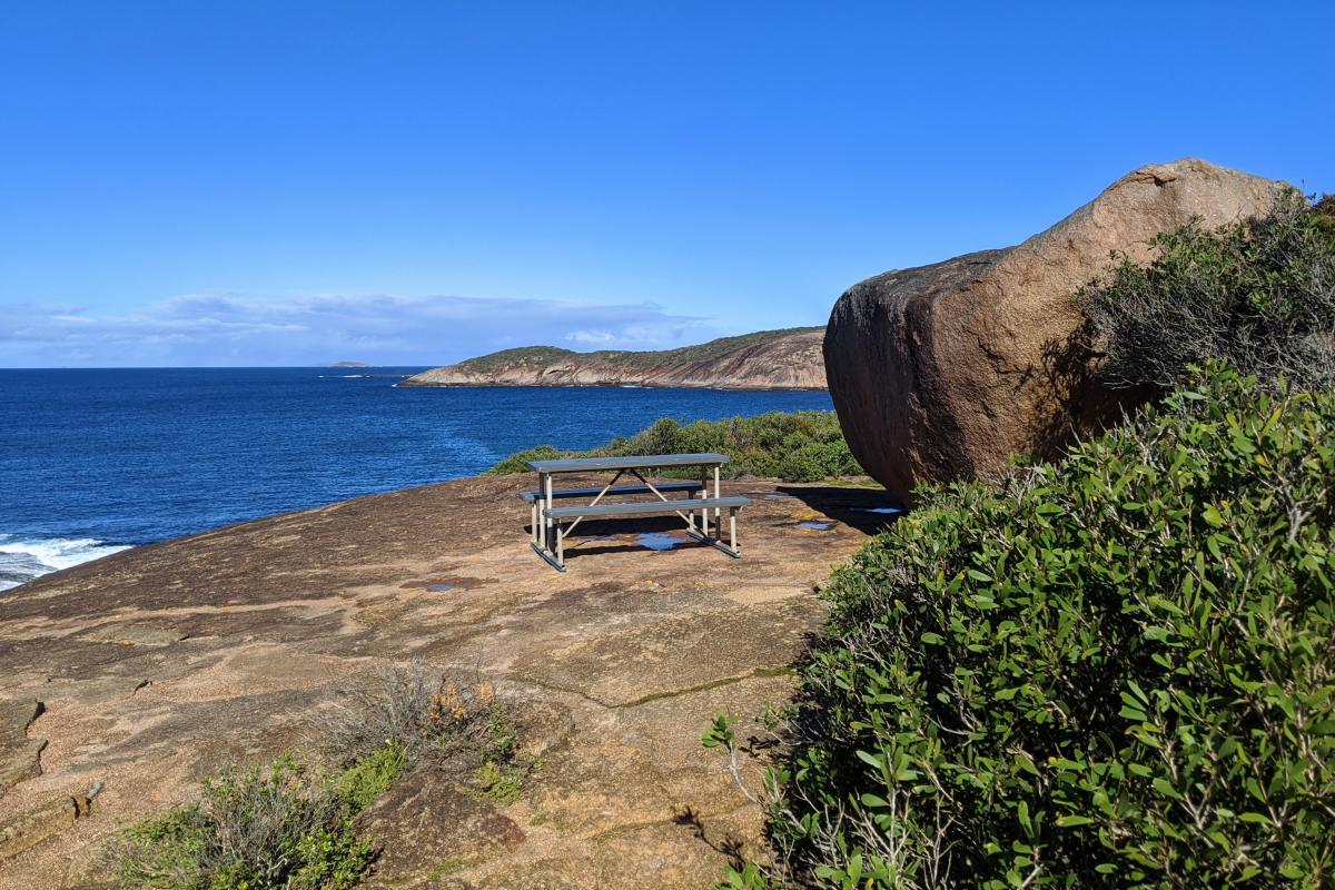 Picnic bench overlooking the ocean on the headland at Thistle Cove