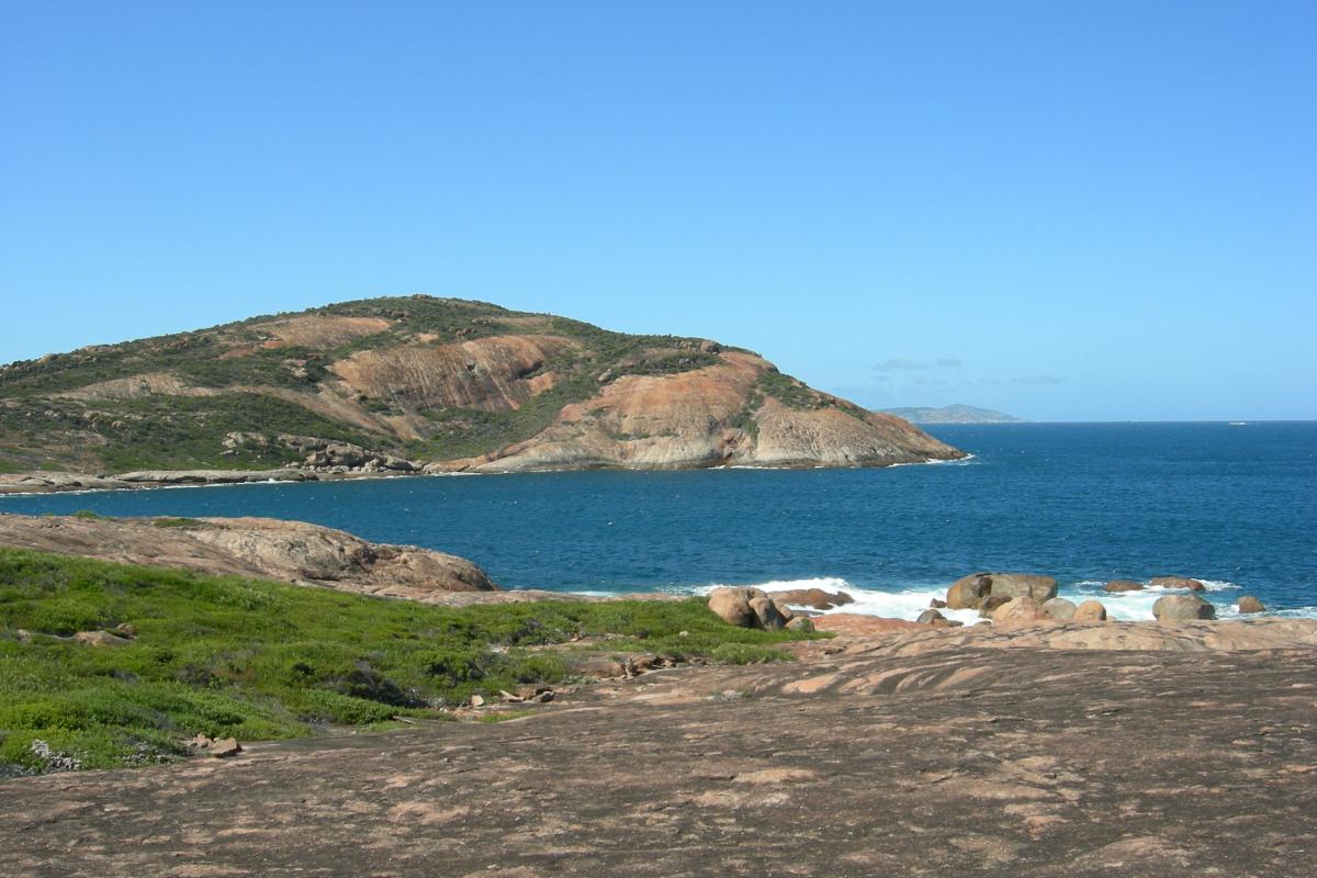 rocks surrounding bay of blue water 
