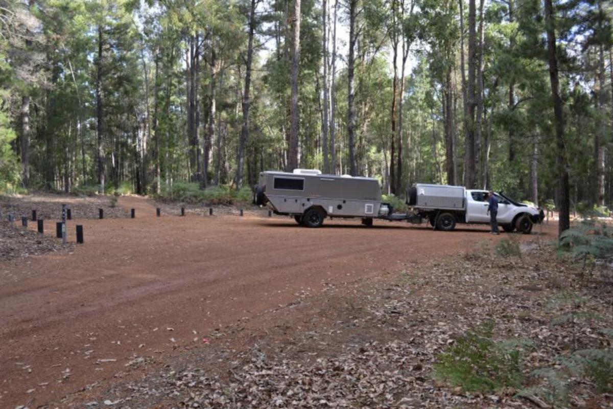 a person with their vehicle and camper trailer at baden powell campground