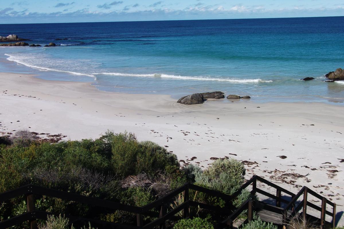 white sandy beach with the ocean rolling in