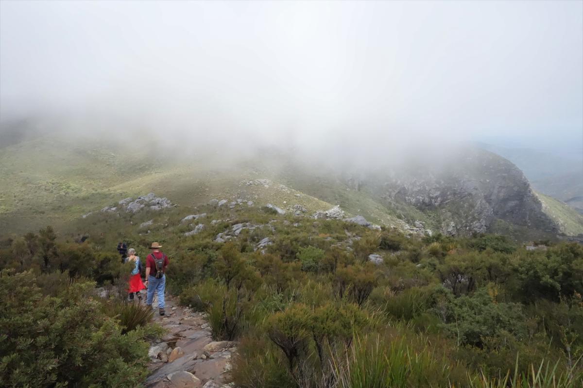 walking on the path down from the summit with heavy cloud on Bluff Knoll 