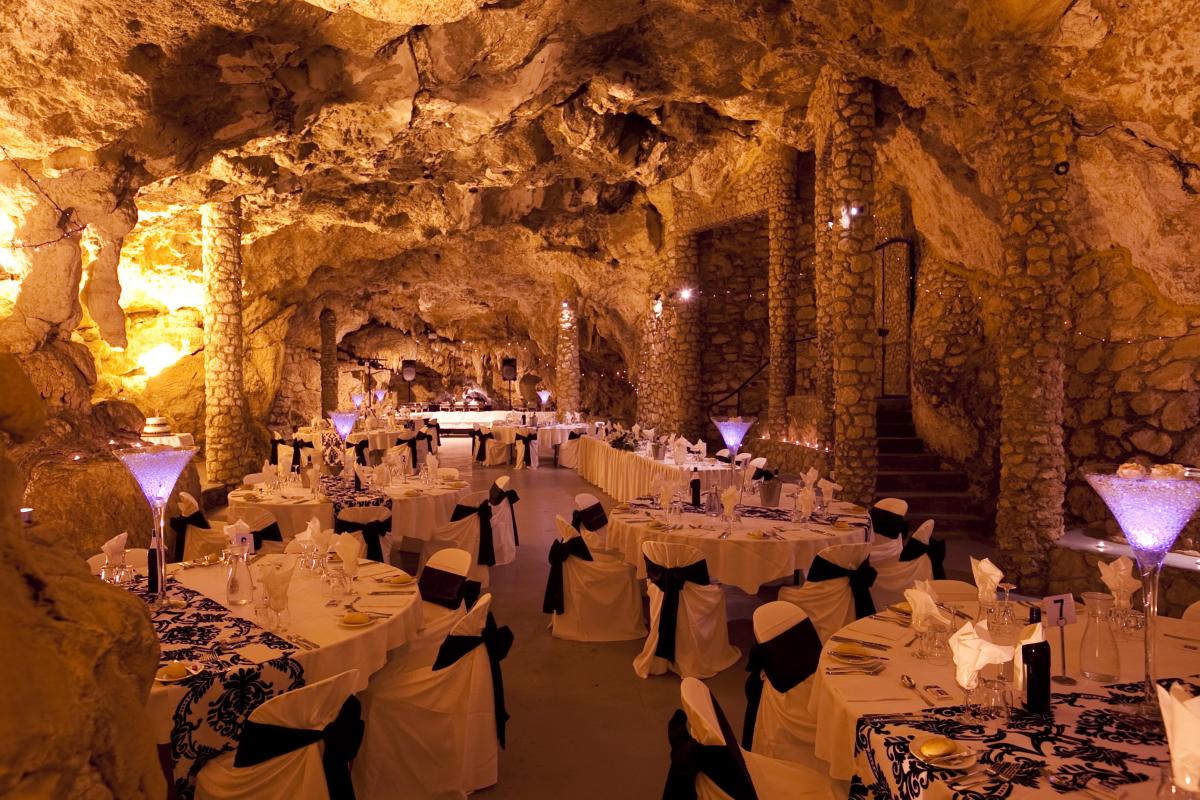 Cabaret Cave, Yanchep National Park Beautifully decorated tables in a cave with creative lighting for functions