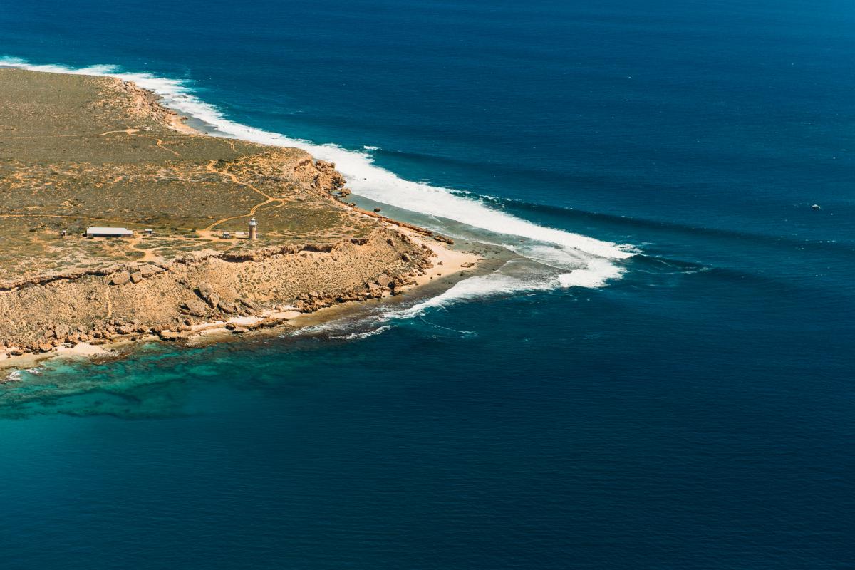 Aerial view of land jutting out into ocean at Cape Inscription