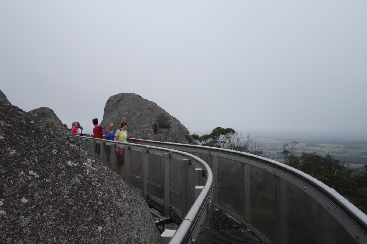 Misty cloud moving in around walkers on the granite skywalk