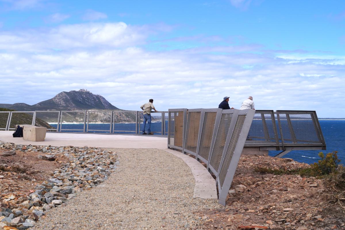 man made metal viewing platform to steep coastal cliffs and a vast blue ocean