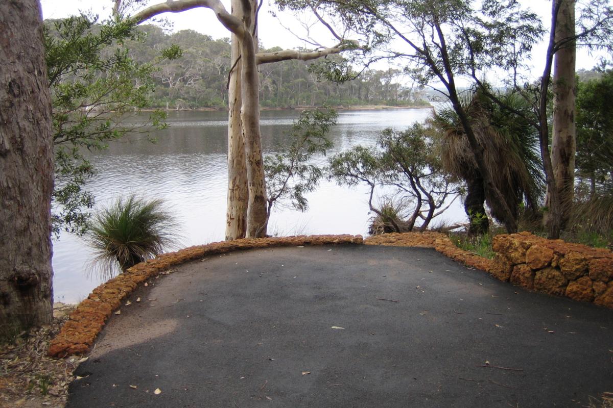 a viewing area on the banks of the walpole inlet with trees and forests over the waters