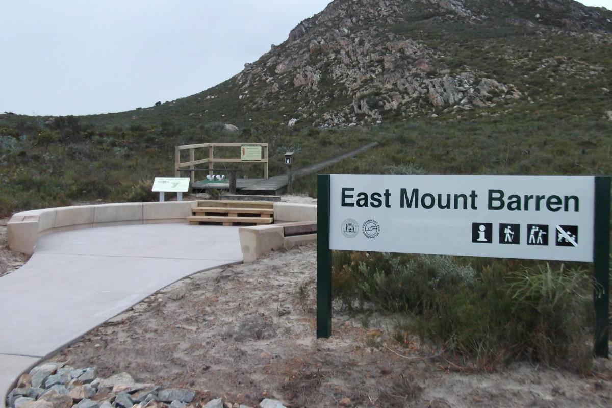 East Mount Barren visitor sign and walkway leading up to a rocky hill