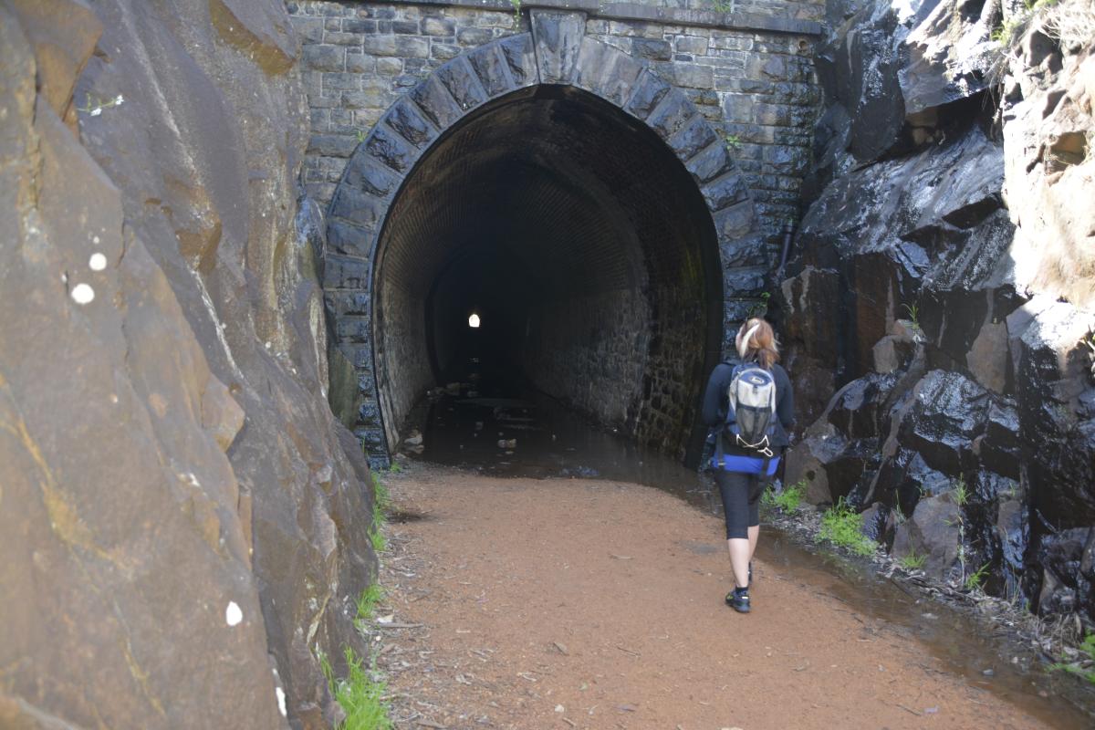 a person walking towards the railway tunnel at john forrest national park