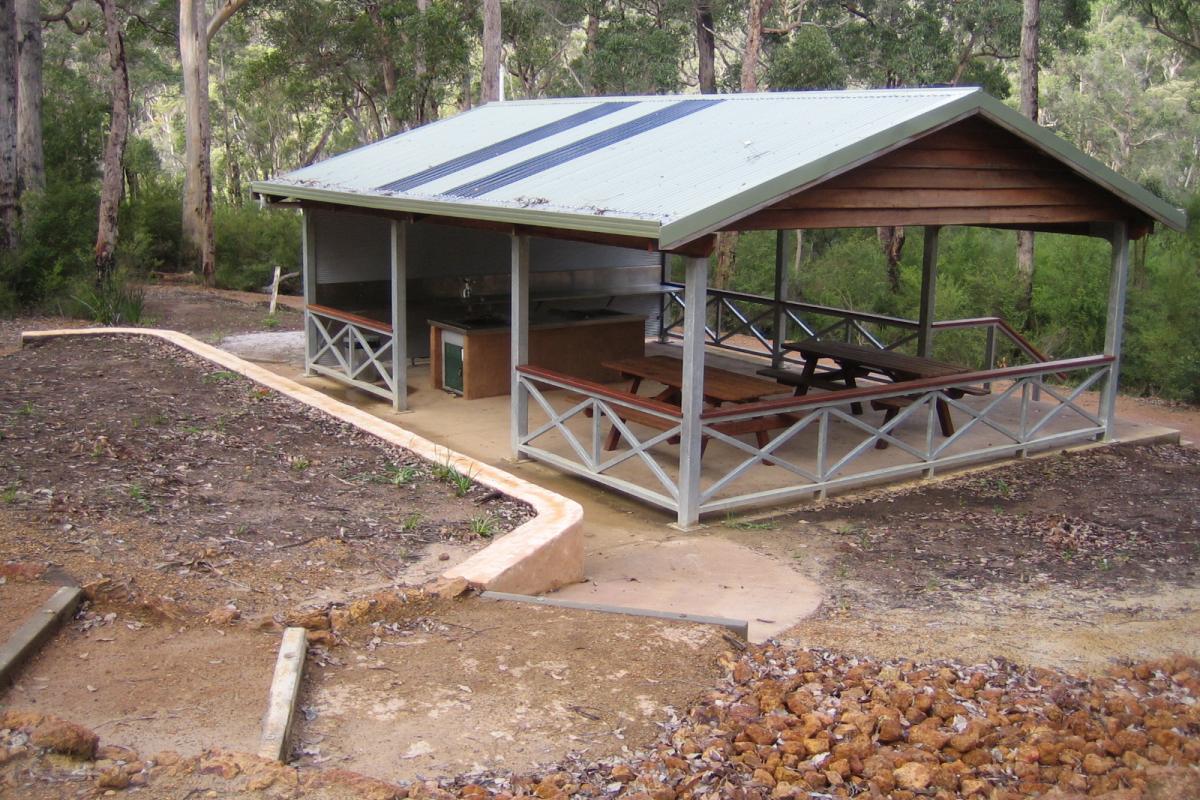 sheltered picnic area and cooking facilities surrounded by forest