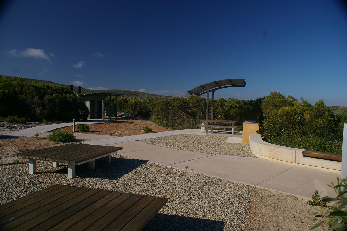 Visitor picnic facilities at Four Mile Beach under a clear blue sky