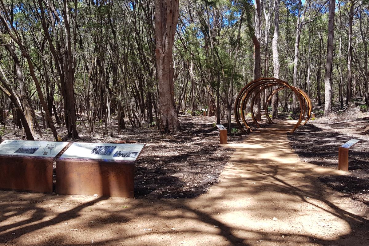 Walk trail through bushland and interpretive signs on the left of the trail