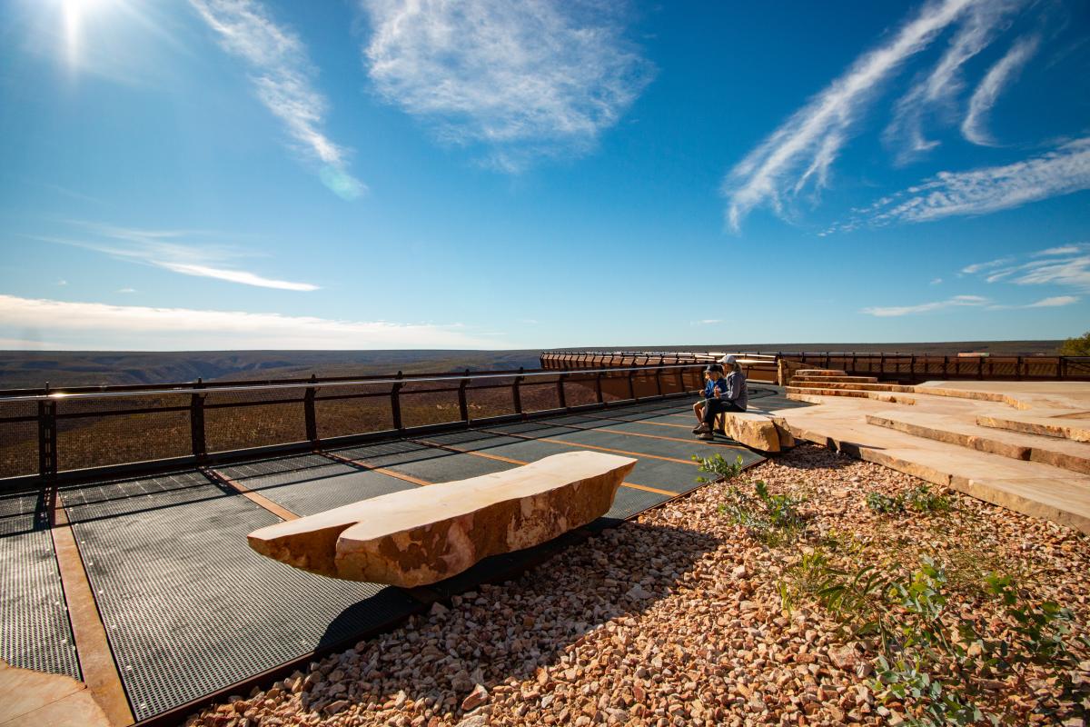 sandstone benches with barrier fencing and steaky clouds in a rich blue sky at Kalbarri Skyalk