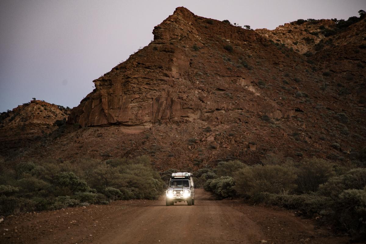 Kennedy Range National Park vehicle with headlites on travelling away from kennedy range