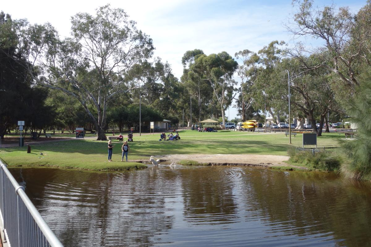 Grassed picnic area with access to the river and cafe and walk trails nearby.