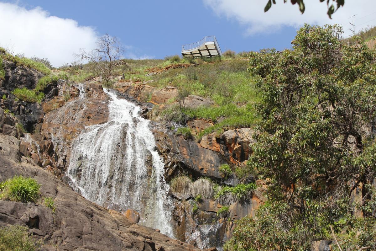 water fall spilling over the rocky hillside