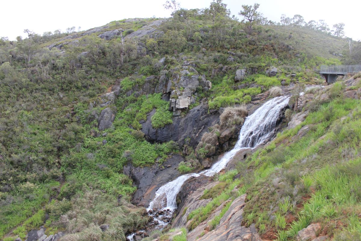 view across to the water falls and rocky hillside in the background