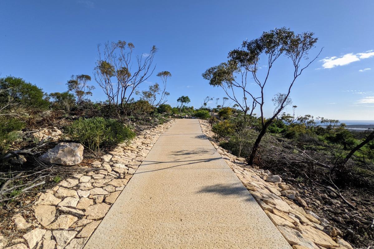 Wide paved pathway from the carpark to the lookouts at Meanarra Hill